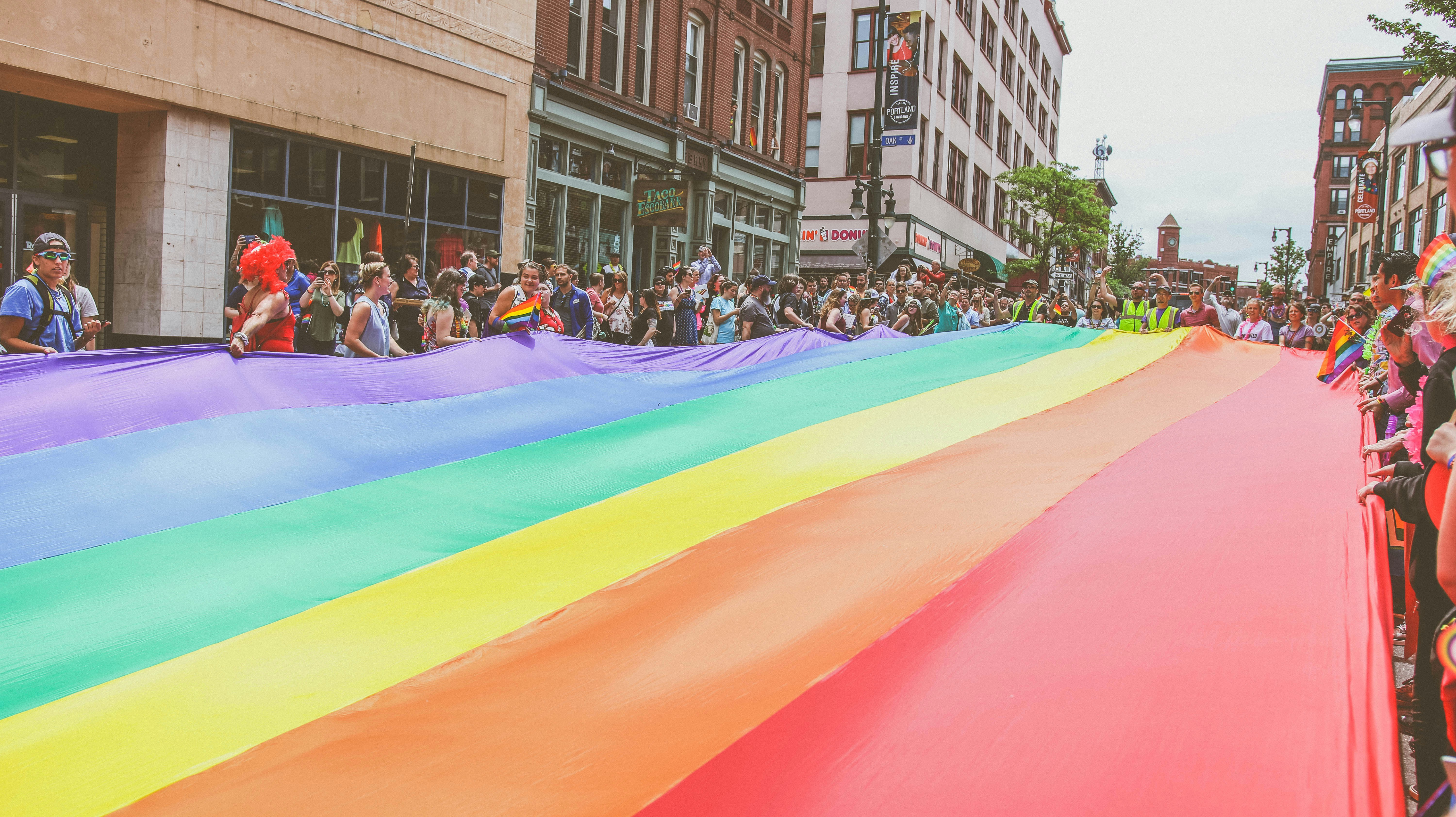 Large rainbow flag across a street